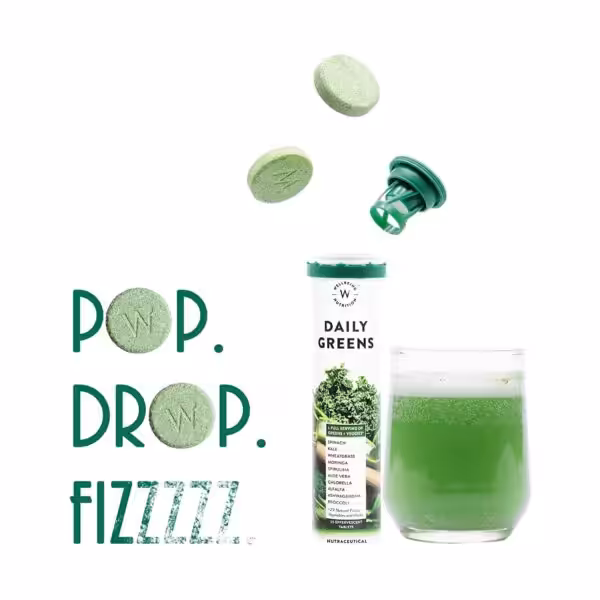 Wellbeing Nutrition Daily Greens effervescent tablets and drink with text POP. DROP. FIZZZZZ