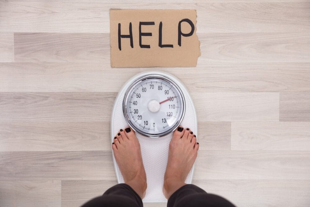 Help Sign With Woman's Feet On Weighing Scale