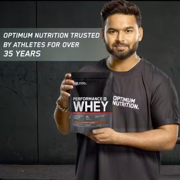 Athlete holding Optimum Nutrition Performance Whey protein bag; text reads Optimum Nutrition trusted by athletes for over 35 years