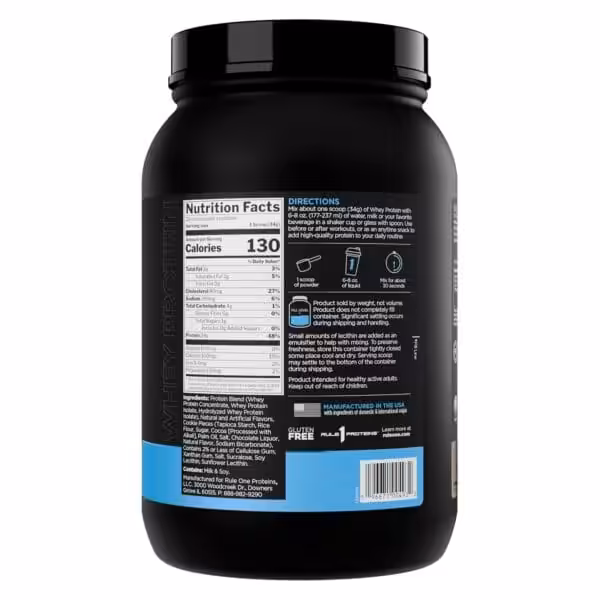 Back label of Rule 1 Whey Protein showing nutrition facts, 130 calories and 24g protein per serving, ingredients, and mixing directions