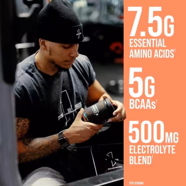 Athlete holding Rule One Essential Amino 9 supplement; 7.5g essential amino acids, 5g BCAAs, 500mg electrolyte blend per serving