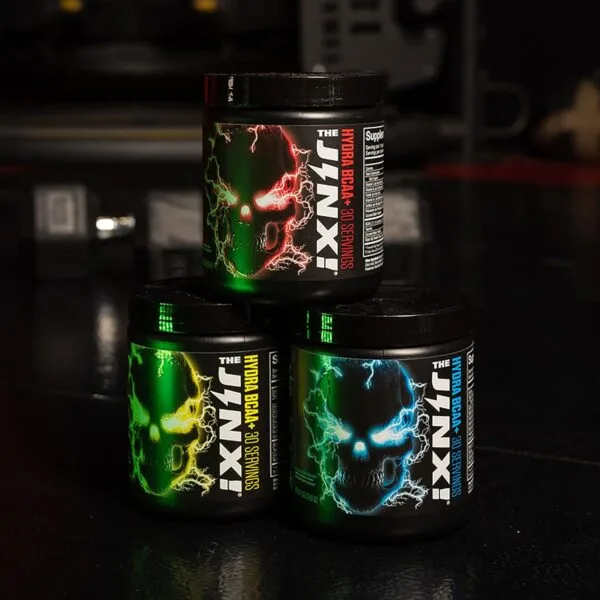 Three tubs of The Jinx Hydra BCAA+ supplement, 30 servings each, in red, yellow, and blue skull label variants