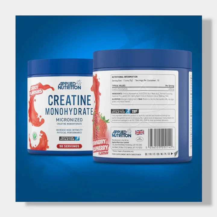 Two blue containers of Applied Nutrition Creatine Monohydrate supplement, one showing juicy flavors and the other detailing strawberry raspberry flavor with nutritional facts, are prominently displayed against a blue and gray backdrop.