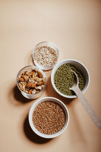 Plant protein sources including grains, seeds and legumes in jars and bowls