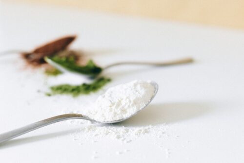 Spoon of plain unflavoured powder illustrating raw whey proteins
